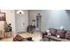 Open living room featuring comfortable seating, skylight, and entertainment center at 210 Cheshire Way, Davenport, FL 33897