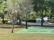 View of basketball court surrounded by mature trees and green space, perfect for outdoor recreation at 3205 Sonesta Ct # B, Clermont, FL 34711