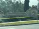 Stone community clubhouse sign with decorative tile and manicured landscaping at 3205 Sonesta Ct # B, Clermont, FL 34711