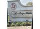 The stone sign for Heritage Hills in a manicured garden at the community entrance at 3205 Sonesta Ct # B, Clermont, FL 34711