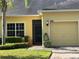 Charming home featuring a well-manicured lawn, and a one car garage with a tan door at 3205 Sonesta Ct # B, Clermont, FL 34711