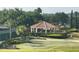 A beautiful gazebo with lush green landscaping surrounded by palm trees and tennis courts at 3205 Sonesta Ct # B, Clermont, FL 34711