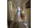 Hallway featuring tile flooring, decor, and access to various rooms, enhancing the home's aesthetic appeal at 3205 Sonesta Ct # B, Clermont, FL 34711