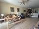 Inviting living room with a ceiling fan, tile flooring, and an open layout, seamlessly connected to the dining area at 3205 Sonesta Ct # B, Clermont, FL 34711