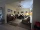 Inviting living room featuring plush seating, piano, ceiling fan and space for entertaining, creating a cozy atmosphere at 3205 Sonesta Ct # B, Clermont, FL 34711
