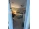 Cozy main bedroom showcasing a ceiling fan and a comfortable bed with a tree wall decoration at 3205 Sonesta Ct # B, Clermont, FL 34711