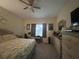 Spacious main bedroom featuring a ceiling fan, a comfortable bed and a large window at 3205 Sonesta Ct # B, Clermont, FL 34711
