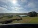 Lovely overlook view with greenery and a pond on a bright and sunny day at 3205 Sonesta Ct # B, Clermont, FL 34711