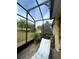 Relaxing screened-in patio with tiled floor and comfortable chair with a view of the backyard at 3205 Sonesta Ct # B, Clermont, FL 34711