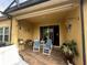 Covered patio area featuring tiled flooring, outdoor furniture, and access to the interior at 3205 Sonesta Ct # B, Clermont, FL 34711