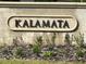 Community entrance sign for Kalamata featuring landscaped flower beds at 3205 Sonesta Ct # B, Clermont, FL 34711