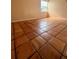 Bedroom featuring neutral paint and tile flooring throughout, and a window for natural light at 1550 11Th Ne St # G8, Winter Haven, FL 33881