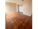 Bedroom featuring neutral paint, tile floors, a closet, and an entrance to another room at 1550 11Th Ne St # G8, Winter Haven, FL 33881
