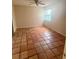 Neutral bedroom featuring a window and tile flooring providing a cozy space to unwind and personalize at 1550 11Th Ne St # G8, Winter Haven, FL 33881