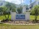 Inviting Lake Buckeye condominium community sign surrounded by lush landscaping and tropical palm trees at 1550 11Th Ne St # G8, Winter Haven, FL 33881