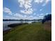 Scenic lake view features lush green landscaping along the shoreline at 1550 11Th Ne St # G8, Winter Haven, FL 33881