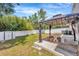 Spacious backyard featuring a metal gazebo, picnic table, white privacy fence, and a storage shed at 2448 Brownwood Dr, Mulberry, FL 33860