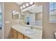 A vanity with a sink with a shower, a bathtub, and a toilet in the adjacent bathroom at 2448 Brownwood Dr, Mulberry, FL 33860
