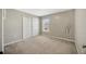 A carpeted bedroom featuring neutral walls, a window, and a closet at 2448 Brownwood Dr, Mulberry, FL 33860