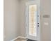 Beautiful front door with decorative glass panel, neutral walls, and tiled flooring at 2448 Brownwood Dr, Mulberry, FL 33860