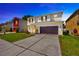 Two-story home featuring a spacious driveway, attached garage, and well-maintained lawn at 2448 Brownwood Dr, Mulberry, FL 33860