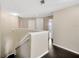 Upstairs hallway featuring dark floors, white walls and trim, and a stairway to the lower level at 2448 Brownwood Dr, Mulberry, FL 33860