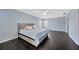Light-filled bedroom with wood floors, large windows, a king-size bed, and a modern ceiling fan at 2448 Brownwood Dr, Mulberry, FL 33860