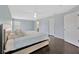 Bright bedroom with wood floors, a ceiling fan, light-blue walls, and a king size bed at 2448 Brownwood Dr, Mulberry, FL 33860