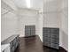 Spacious walk-in closet featuring built in shelves and drawers, and wood-look flooring at 2448 Brownwood Dr, Mulberry, FL 33860
