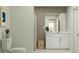 Bright bathroom featuring a vanity with white cabinetry, stylish mirror, and shower with a patterned curtain at 1333 Acorn Meadow Loop, Eustis, FL 32726