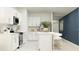 Well-equipped modern kitchen with white cabinets, stainless steel appliances, and an island with bar stool seating at 1333 Acorn Meadow Loop, Eustis, FL 32726