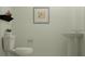 Simple half bathroom with pedestal sink, toilet, and modern decor at 1373 Acorn Meadow Loop, Eustis, FL 32726