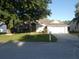 Traditional-style home featuring a well-manicured lawn and attached two-car garage at 566 Montana Ave, Davenport, FL 33897