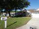 Charming single-Gathering home with well-manicured front lawn and mailbox at 566 Montana Ave, Davenport, FL 33897