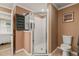 Well-lit bathroom featuring a glass enclosed shower, with stack of towels, and modern toilet at 2522 Pine Valley Dr, Lakeland, FL 33810