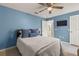 Relaxing bedroom featuring tile floors, a ceiling fan, and access to an en-suite bathroom at 2522 Pine Valley Dr, Lakeland, FL 33810