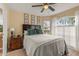 Bedroom with tile floor, queen bed, tasteful decor, and a sun-filled arched window at 2522 Pine Valley Dr, Lakeland, FL 33810