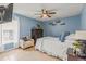 Comfortable bedroom with blue walls, tile floor, and cozy reading chair at 2522 Pine Valley Dr, Lakeland, FL 33810