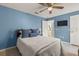 Comfortable bedroom with blue walls, ceiling fan, and cozy bedding at 2522 Pine Valley Dr, Lakeland, FL 33810