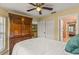 Bedroom featuring a wooden wardrobe, white bedding, and ceiling fan at 2522 Pine Valley Dr, Lakeland, FL 33810