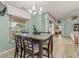 Inviting dining area featuring a granite table with chandelier lighting and views of the backyard at 2522 Pine Valley Dr, Lakeland, FL 33810