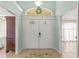 Elegant entryway boasts decorative glass doors, transom window with wreath, and neutral tile flooring at 2522 Pine Valley Dr, Lakeland, FL 33810