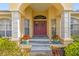 Charming front porch adorned with potted plants and decorative wreaths at 2522 Pine Valley Dr, Lakeland, FL 33810