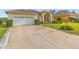 Lovely home featuring a large driveway, two car garage, and manicured front lawn at 2522 Pine Valley Dr, Lakeland, FL 33810
