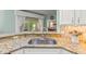 Granite countertops highlight the kitchen's stainless steel sink and tile backsplash at 2522 Pine Valley Dr, Lakeland, FL 33810