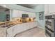 Modern kitchen with granite countertops, white cabinetry, and stainless steel appliances at 2522 Pine Valley Dr, Lakeland, FL 33810