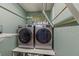 Well-lit laundry room featuring modern washer and dryer, plus overhead drying rack at 2522 Pine Valley Dr, Lakeland, FL 33810