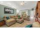 Spacious living room features a large sectional sofa, tile flooring, and sliding glass doors to the backyard at 2522 Pine Valley Dr, Lakeland, FL 33810