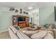 Open-concept living room features a large sectional, media center, and views of the front entrance at 2522 Pine Valley Dr, Lakeland, FL 33810