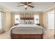 Spacious bedroom featuring neutral tones, a ceiling fan, and a comfortable bed at 2522 Pine Valley Dr, Lakeland, FL 33810